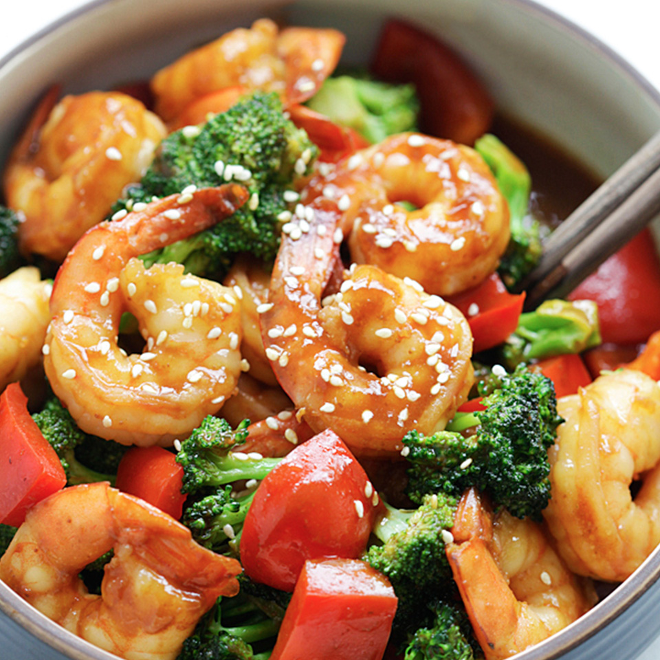 A close up of a bowl with San-J hoisin shrimp with broccoli