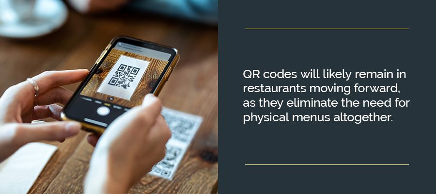 Woman scanning a qr code with her smart phone to access a menu